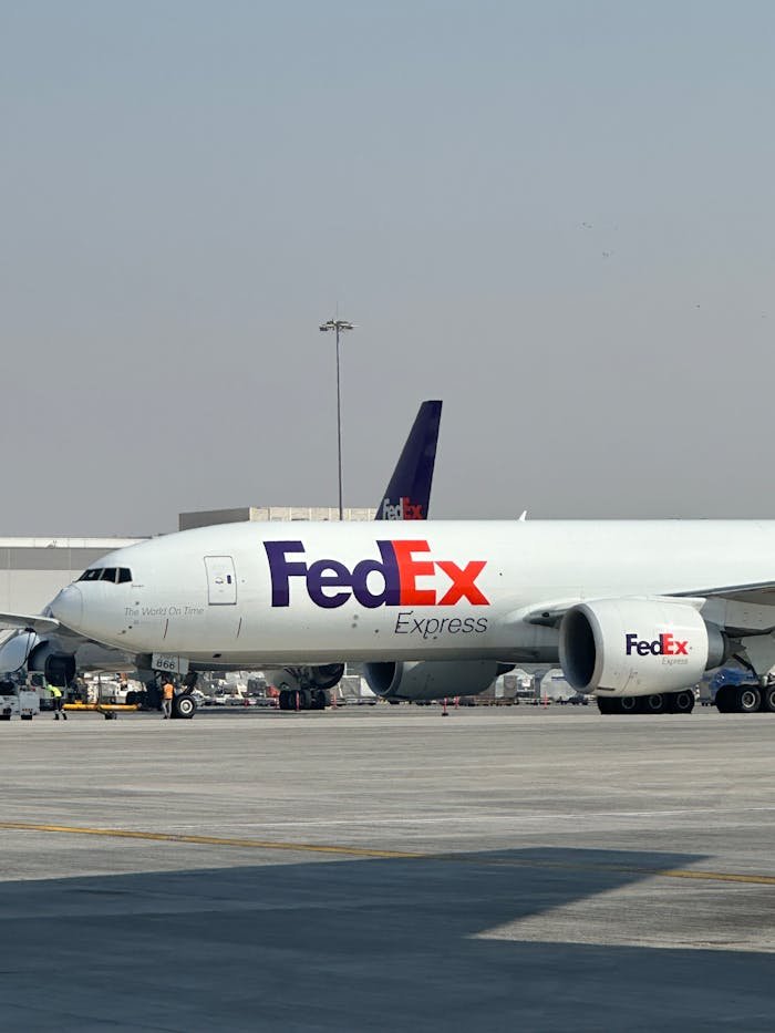services-04 FedEx cargo aircraft parked at Dubai International Airport on a clear day.