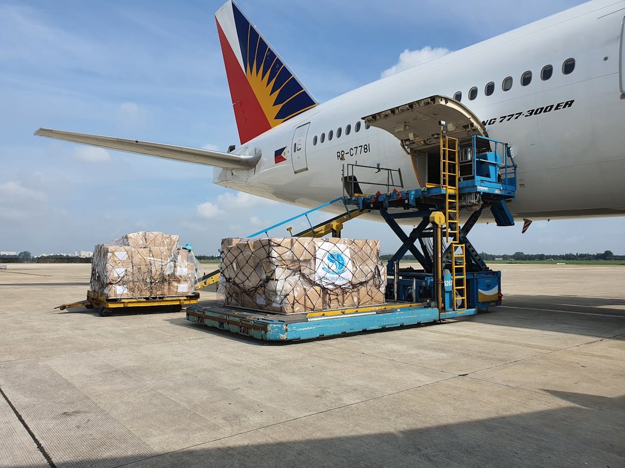 services-02 Cargo being loaded onto a commercial airplane at an airport in Ho Chi Minh City, Vietnam.